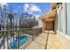 A gorgeous tiled balcony overlooks the pool and a lovely view of the surrounding nature at 17336 Ballmont Park Dr, Odessa, FL 33556