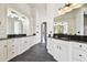 Bright bathroom with tiled floors, double sinks, and dark granite countertops at 17336 Ballmont Park Dr, Odessa, FL 33556