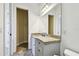 Bathroom vanity with stone countertops and neutral colored walls, and a large walk-in closet at 17336 Ballmont Park Dr, Odessa, FL 33556