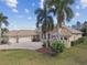 Elegant home showcasing a three-car garage, tile roof, and verdant lawn at 17336 Ballmont Park Dr, Odessa, FL 33556