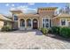 Attractive home entrance with arched entryways, double doors, and a brick paver driveway at 17336 Ballmont Park Dr, Odessa, FL 33556