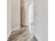 Bright hallway features beautiful wood-style flooring and multiple doorways at 17336 Ballmont Park Dr, Odessa, FL 33556