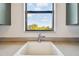 Close up of the laundry sink, set in a spacious countertop and offering a view of the outdoors at 17336 Ballmont Park Dr, Odessa, FL 33556