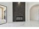 Living room featuring a modern stone fireplace with marble floors leading to an outdoor entryway at 17336 Ballmont Park Dr, Odessa, FL 33556