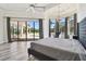 Bright main bedroom showcasing wood flooring, a tray ceiling, and large windows at 17336 Ballmont Park Dr, Odessa, FL 33556