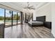 Spacious main bedroom featuring wood floors, a king bed, and views of the pool at 17336 Ballmont Park Dr, Odessa, FL 33556