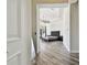 View of main bedroom showcasing wood flooring, a tray ceiling, and a tufted headboard bed at 17336 Ballmont Park Dr, Odessa, FL 33556