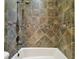 Shower stall with decorative tile and bronze fixtures for a timeless design at 17336 Ballmont Park Dr, Odessa, FL 33556