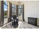 Sitting area features lots of natural light, a chandelier, and wood flooring at 17336 Ballmont Park Dr, Odessa, FL 33556