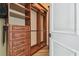 Walk-in closet features custom wood drawers, shelving, and metal hanging rods at 17336 Ballmont Park Dr, Odessa, FL 33556