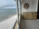 Balcony with ocean view, wet bar, and ship's wheel at 17900 Gulf Blvd # 16C, Redington Shores, FL 33708