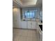 White kitchen with ocean view from window at 17900 Gulf Blvd # 16C, Redington Shores, FL 33708