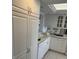 White kitchen with double sink and dishwasher at 17900 Gulf Blvd # 16C, Redington Shores, FL 33708