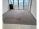 Living area with carpeted floor and access to balcony with ocean view at 17900 Gulf Blvd # 16C, Redington Shores, FL 33708