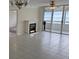 Living room with fireplace, tile floor, and ocean view at 17900 Gulf Blvd # 16C, Redington Shores, FL 33708