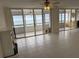 Bright living room with tiled floors and sliding doors leading to balcony with ocean view at 17900 Gulf Blvd # 16C, Redington Shores, FL 33708