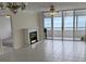 Living room with fireplace, tile floor, and ocean view at 17900 Gulf Blvd # 16C, Redington Shores, FL 33708