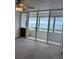 Living area with ocean view, carpeted floor, and sliding glass doors to balcony at 17900 Gulf Blvd # 16C, Redington Shores, FL 33708