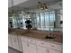 Wet bar with mirrored backsplash and cabinets at 17900 Gulf Blvd # 16C, Redington Shores, FL 33708