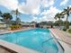 Relaxing community pool with surrounding patio furniture at 1799 N Highland Ave # 99, Clearwater, FL 33755