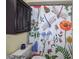 Bathroom with floral shower curtain and dark wood cabinet at 1801 E Lake Rd # 15C, Palm Harbor, FL 34685