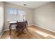 Simple bedroom with hardwood floors, a writing desk, and a window with blinds at 1801 E Lake Rd # 15C, Palm Harbor, FL 34685