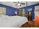 Spacious bedroom with wood floors and a four-poster bed at 1801 E Lake Rd # 15C, Palm Harbor, FL 34685