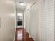 Bright hallway with hardwood floors and multiple closets at 1801 E Lake Rd # 15C, Palm Harbor, FL 34685