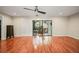 Spacious living room with hardwood floors and access to a patio at 1801 E Lake Rd # 15C, Palm Harbor, FL 34685