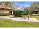 Community picnic area with a table, benches, and umbrella at 1801 E Lake Rd # 15C, Palm Harbor, FL 34685