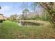 Landscaped backyard with a serene pond at 1801 E Lake Rd # 15C, Palm Harbor, FL 34685