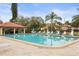 Community pool area with covered patio and plenty of lounge chairs at 1801 E Lake Rd # 15C, Palm Harbor, FL 34685