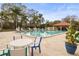 Relaxing community pool with tables and chairs at 1801 E Lake Rd # 15C, Palm Harbor, FL 34685