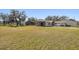 Large backyard with grassy area and mature trees at 18419 Tyler Rd, Odessa, FL 33556