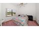 Charming bedroom with floral bedding and large window at 18419 Tyler Rd, Odessa, FL 33556