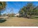 Ranch-style home with a screened pool and lush yard at 18419 Tyler Rd, Odessa, FL 33556