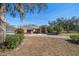 House exterior featuring a red door and two-car garage at 18419 Tyler Rd, Odessa, FL 33556