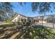 Back exterior view showcasing a home with a screened patio at 18419 Tyler Rd, Odessa, FL 33556