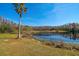 Peaceful waterfront property with a palm tree and calm waters at 18419 Tyler Rd, Odessa, FL 33556