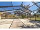 Large screened patio with concrete flooring overlooking the backyard at 18419 Tyler Rd, Odessa, FL 33556