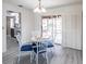 Dining area with glass table and blue chairs, opens to the backyard at 18719 Van Nuys Cir, Port Charlotte, FL 33948