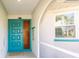 Front entrance with a teal door and glass sidelight, welcoming and bright at 18719 Van Nuys Cir, Port Charlotte, FL 33948