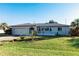 Single-story home with a gray exterior, attached garage, and well-maintained lawn at 18719 Van Nuys Cir, Port Charlotte, FL 33948