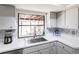 Clean and efficient kitchen with stainless steel sink and modern backsplash at 18719 Van Nuys Cir, Port Charlotte, FL 33948