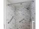 Walk-in shower with marble tile and safety bars at 18719 Van Nuys Cir, Port Charlotte, FL 33948