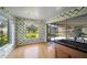 Light-filled dining area with wood floors and view of backyard at 2389 Sarazen Dr, Dunedin, FL 34698