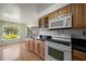 Eat-in kitchen with wood cabinets, granite counters and window at 2389 Sarazen Dr, Dunedin, FL 34698