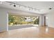 Living room with sliding glass doors leading to backyard at 2389 Sarazen Dr, Dunedin, FL 34698