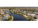 Aerial view showcasing a house's location on a tranquil lake at 26853 Winged Elm Dr, Wesley Chapel, FL 33544