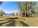 Peaceful backyard with lake view and lush landscaping at 26853 Winged Elm Dr, Wesley Chapel, FL 33544